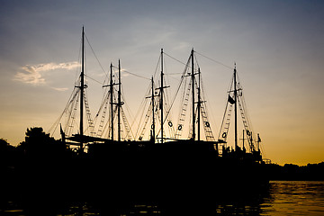 Image showing sunset silhouettes of sailing vessels 