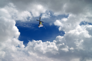 Image showing Freestyle ski jumper with crossed skis 