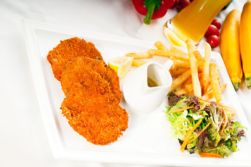 Image showing classic Milanese veal cutlets and vegetables