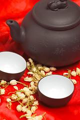 Image showing jasmine tea over red silk