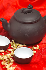 Image showing jasmine tea over red silk