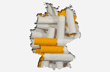 Image showing Outline map of Germany with cigarettes in background