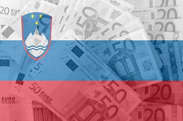 Image showing flag of Slovenia with transparent euro banknotes in background 