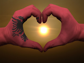 Image showing Heart and love gesture by hands colored in albania flag during b