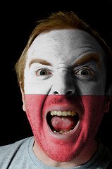 Image showing Face of crazy angry man painted in colors of poland flag