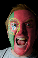 Image showing Face of crazy angry man painted in colors of portugal flag