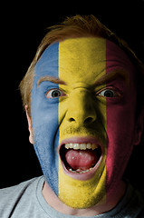 Image showing Face of crazy angry man painted in colors of romania flag