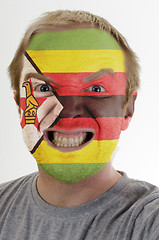 Image showing Face of crazy angry man painted in colors of zimbabwe flag