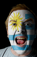 Image showing Face of crazy angry man painted in colors of uruguay flag