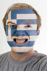 Image showing Face of crazy angry man painted in colors of greece flag