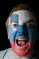 Image showing Face of crazy angry man painted in colors of slovenia flag