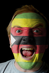 Image showing Face of crazy angry man painted in colors of zimbabwe flag