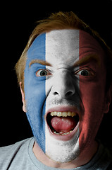 Image showing Face of crazy angry man painted in colors of france flag