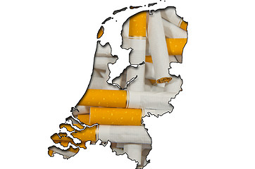 Image showing Outline map of Netherlands with cigarettes in background