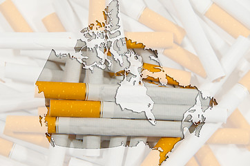 Image showing Map of Canada with cigarettes in background