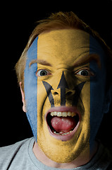 Image showing Face of crazy angry man painted in colors of Barbados flag