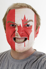 Image showing Face of crazy angry man painted in colors of canada flag