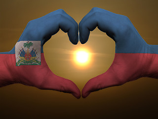 Image showing Heart and love gesture by hands colored in haiti flag during bea