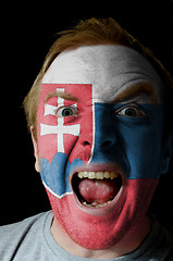 Image showing Face of crazy angry man painted in colors of slovakia flag