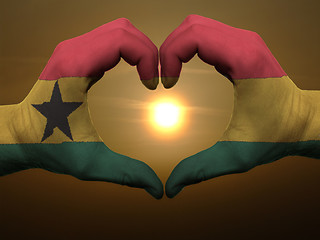 Image showing Heart and love gesture by hands colored in ghana flag during bea
