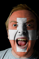 Image showing Face of crazy angry man painted in colors of swiss flag