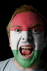 Image showing Face of crazy angry man painted in colors of hungary flag