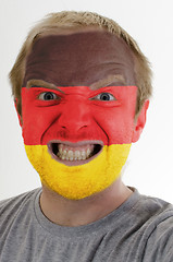 Image showing Face of crazy angry man painted in colors of german flag