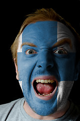 Image showing Face of crazy angry man painted in colors of finland flag