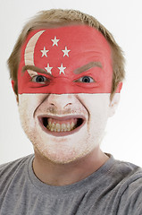 Image showing Face of crazy angry man painted in colors of singapore flag