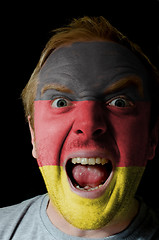 Image showing Face of crazy angry man painted in colors of germany flag