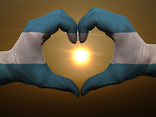 Image showing Heart and love gesture by hands colored in el salvador flag duri