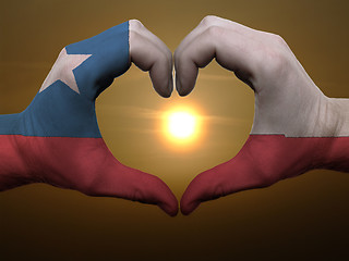 Image showing Heart and love gesture by hands colored in chile flag during bea