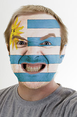 Image showing Face of crazy angry man painted in colors of Uruguay flag