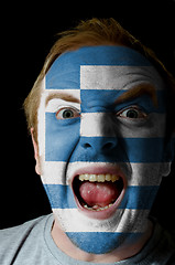 Image showing Face of crazy angry man painted in colors of greece flag