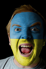 Image showing Face of crazy angry man painted in colors of ukraine flag