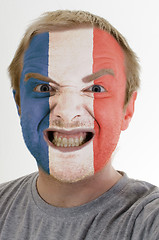 Image showing Face of crazy angry man painted in colors of france flag