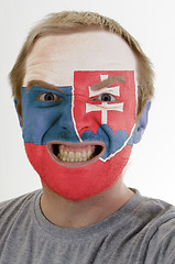 Image showing Face of crazy angry man painted in colors of slovakia flag