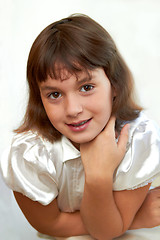 Image showing pretty little girl smiling with hand on chin