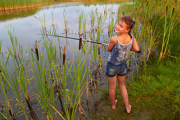 Image showing pretty young girl fishing on river in summer