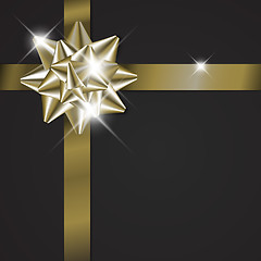 Image showing Golden bow on a ribbon with black background