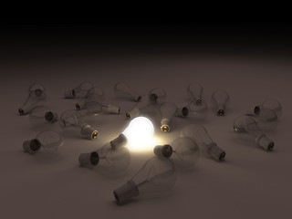 Image showing One lit light bulb amongst other broken light bulbs 