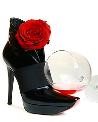 Image showing Glass, beautiful boots and a rose on a white background.