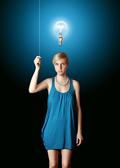 Image showing blonde in blue turn on the light