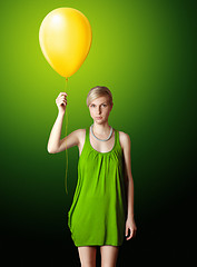 Image showing blonde in green dress with the yellow balloon