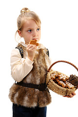 Image showing Little girl with a basket and Christmas cookies.
