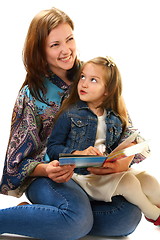 Image showing Merry mother and the little girl reading a book. 