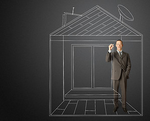 Image showing asian businessman with marker in fictional house