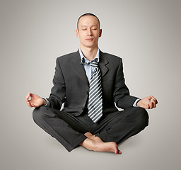 Image showing businessman in lotus pose meditating