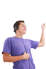 Image showing Smiling young man listen music with headphones