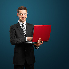 Image showing male in suit with laptop in his hands